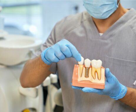 dentist-holding-dental-bridge
